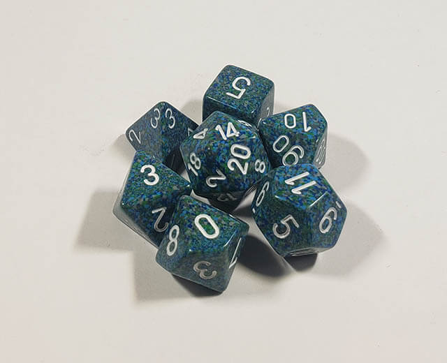 A close up of the Chessex specked Sea polyhedral dice set.