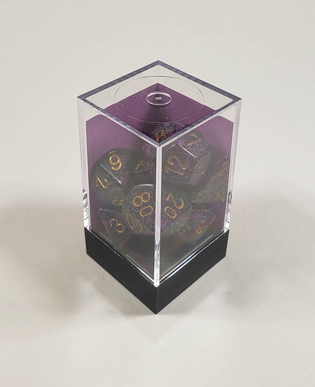 A close up of the Chessex specked Hurricane polyhedral dice set in its package.