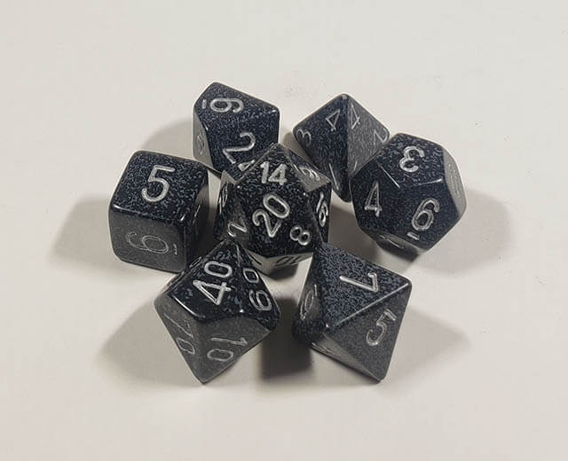 A close up of the Chessex specked Ninja polyhedral dice set.