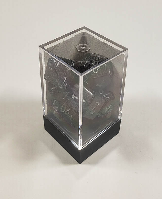 A close up of the Chessex specked Ninja polyhedral dice set in its package.