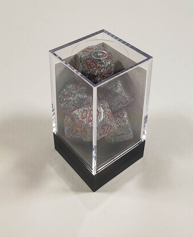 A close up of the Chessex specked Granite polyhedral dice set in its package.