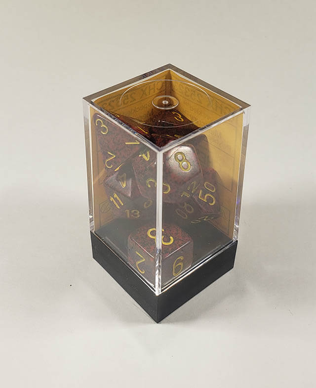 A close up of the Chessex specked Mercury polyhedral dice set in its package.