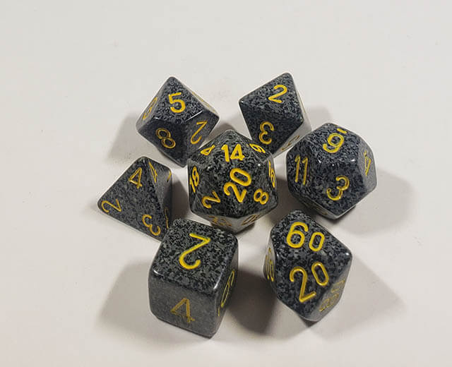 A close up of the Chessex specked Urban Camo polyhedral dice set.
