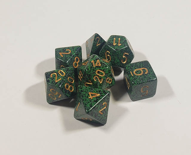 A close up of the Chessex specked Golden Recon  polyhedral dice set.