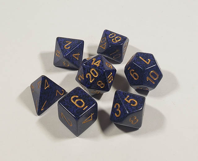 A close up of the Chessex specked Golden Cobalt polyhedral dice set.