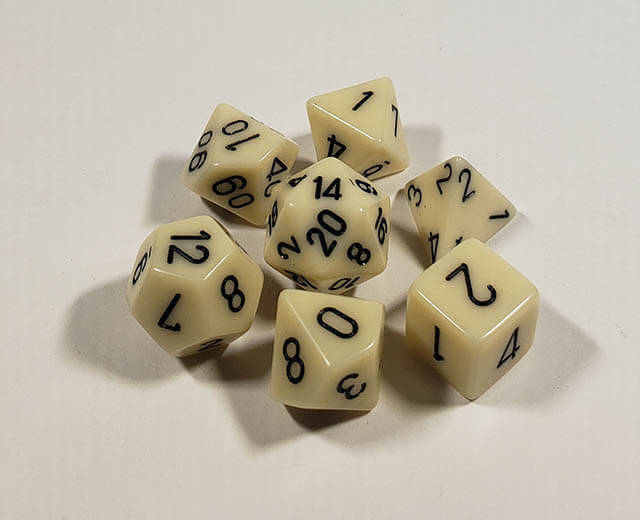A close up of the Chessex Opaque Ivory with black polyhedral dice set.