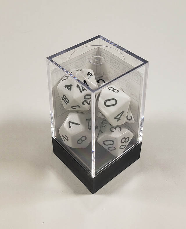 A close up of the Chessex Opaque White with black polyhedral dice set in its package.