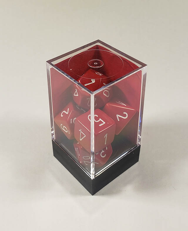 A close up of the Chessex Opaque Red with White polyhedral dice set in its package.