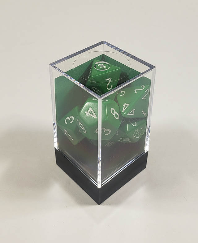 A close up of the Chessex Opaque Green with White polyhedral dice set in its package.