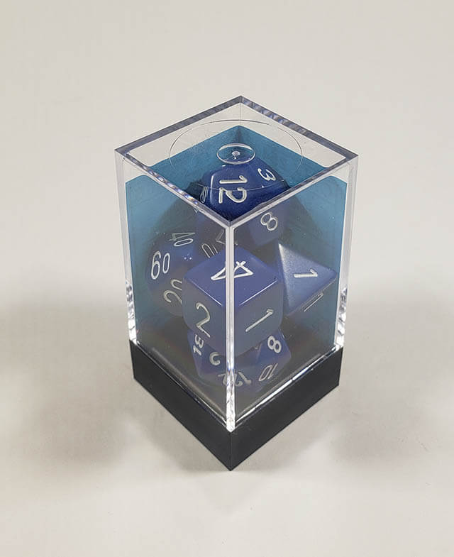A close up of the Chessex Opaque Blue with white polyhedral dice set in its package.