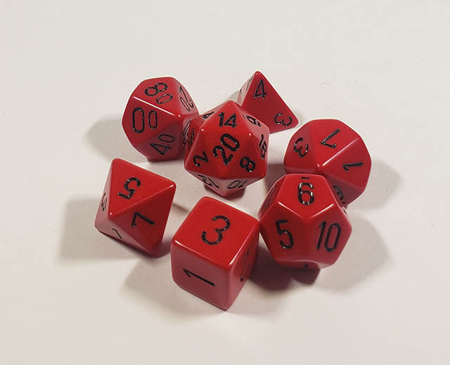 A close up of the Chessex Opaque Red with Black polyhedral dice set.