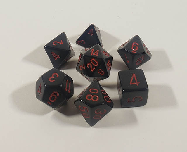 A close up of the Chessex Opaque Black with red polyhedral dice set.