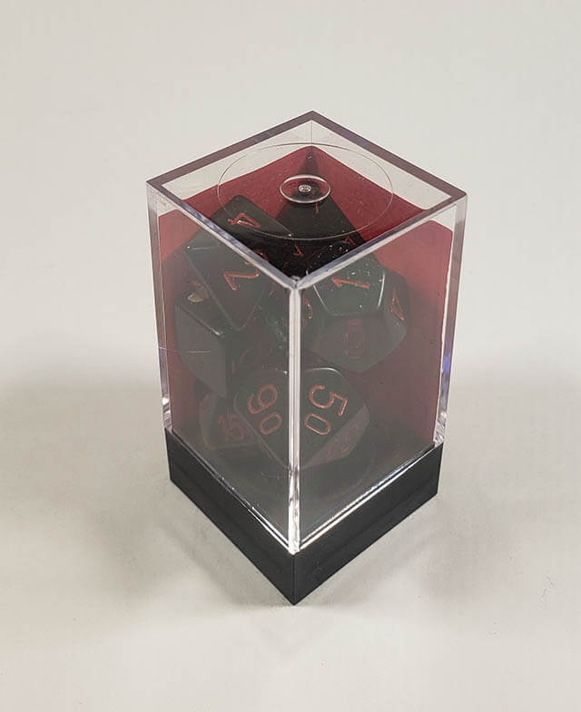 A close up of the Chessex Opaque Black with red polyhedral dice set in its package.