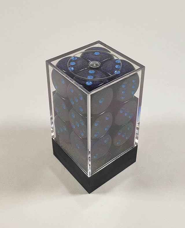 A close up of the Chessex specked cobalt 16mm d6 dice set in its package.