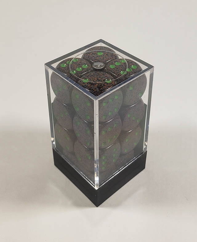 A close up of the Chessex specked earth 16mm d6 dice set in its package.