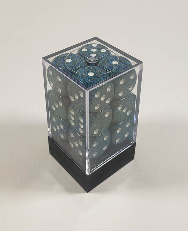 A close up of the Chessex specked sea 16mm d6 dice set in its package.