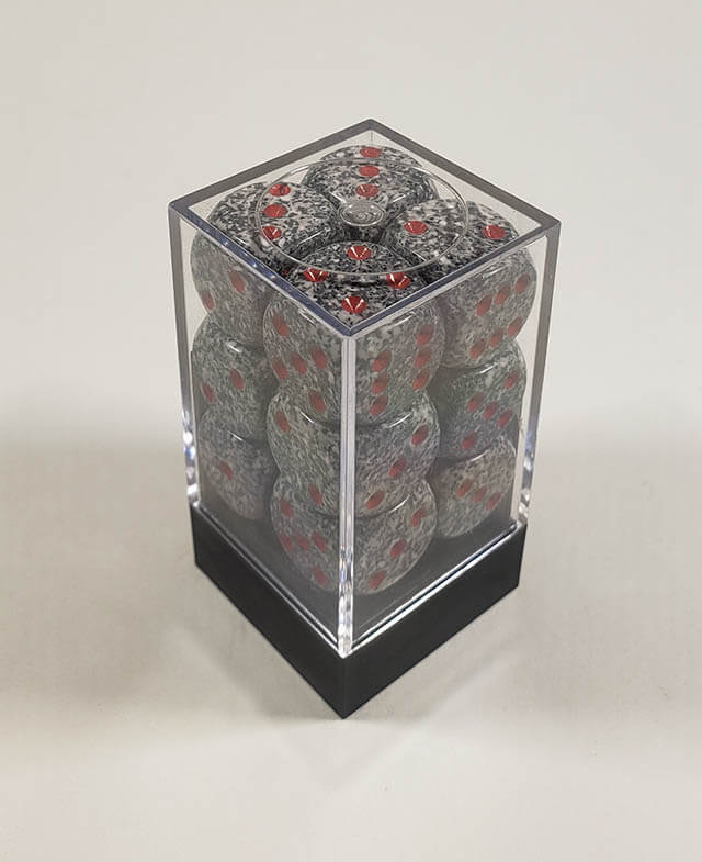 A close up of the Chessex specked granite 16mm d6 dice set in its package.