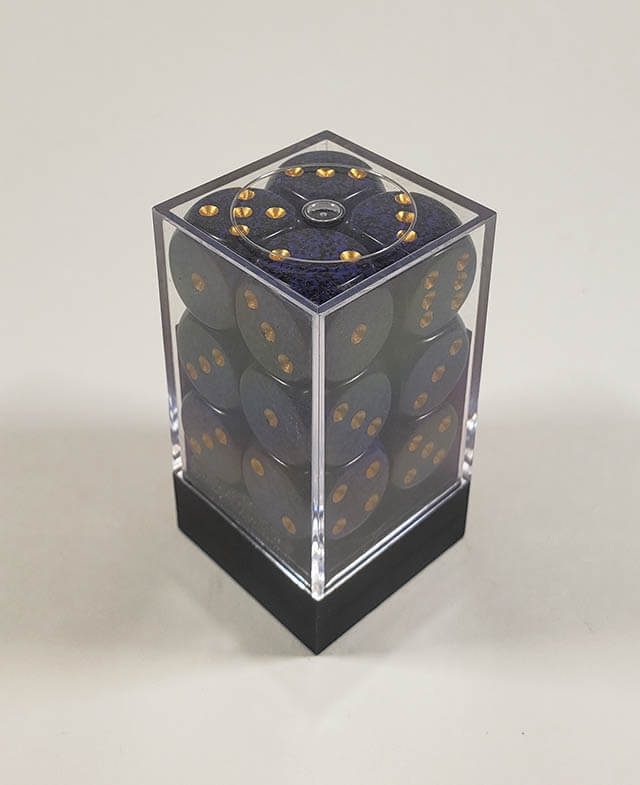 A close up of the Chessex specked golden cobalt 16mm d6 dice set in its package.