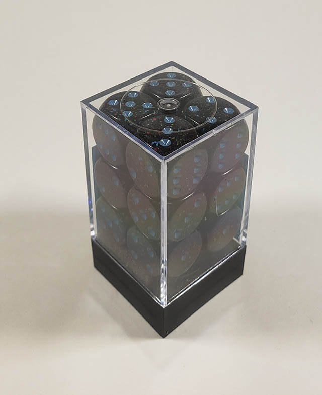 A close up of the Chessex specked blue stars 16mm d6 dice set in its package.