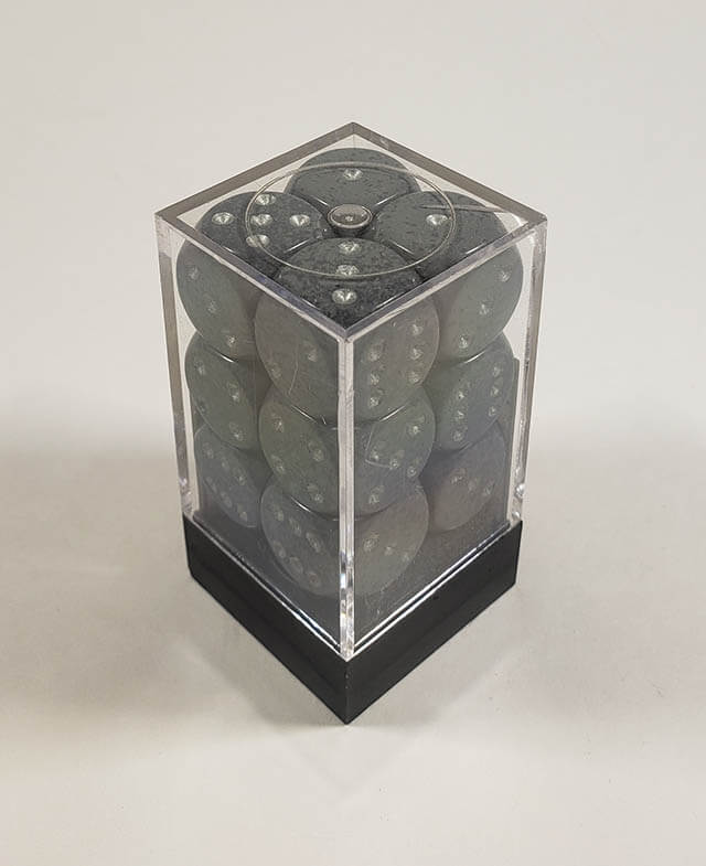 A close up of the Chessex specked hi-tech 16mm d6 dice set in its package.