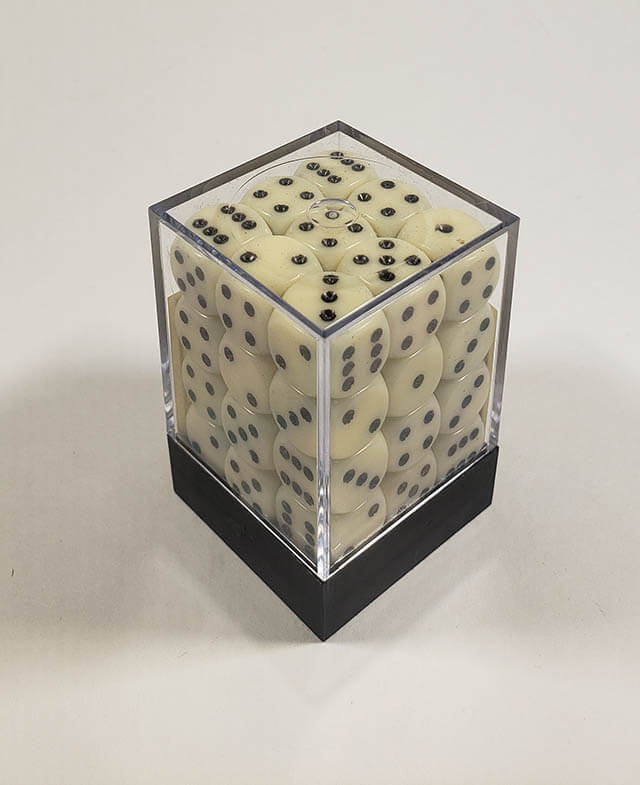 A close up of the Chessex Opaque Ivory with Black 12mm d6 dice set in its package.