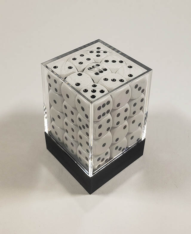 A close up of the Chessex Opaque White with Black 12mm d6 dice set in its package.