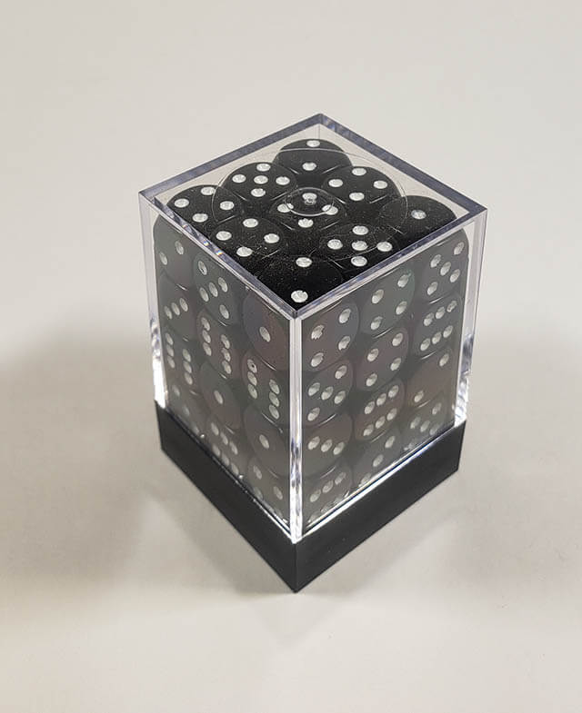 A close up of the Chessex Opaque Black with White 12mm d6 dice set in its package.