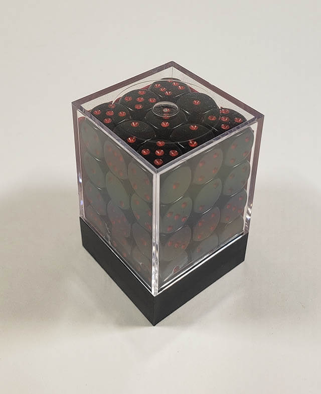 A close up of the Chessex Opaque Black with Red 12mm d6 dice set in its package.