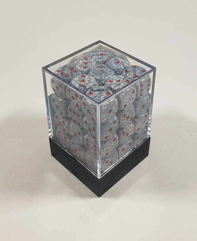 A close up of the Chessex specked air 12mm d6 dice set in its package.