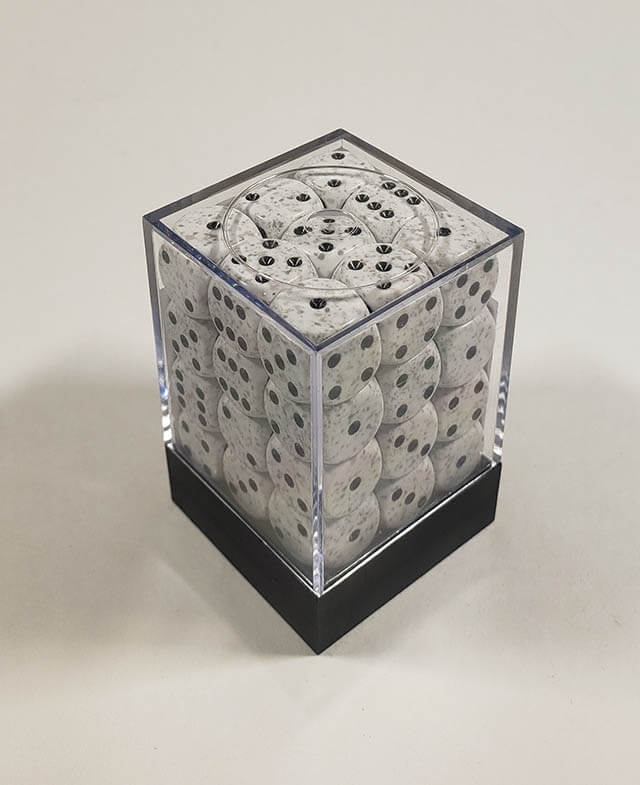 A close up of the Chessex specked arctic camo 12mm d6 dice set in its package.