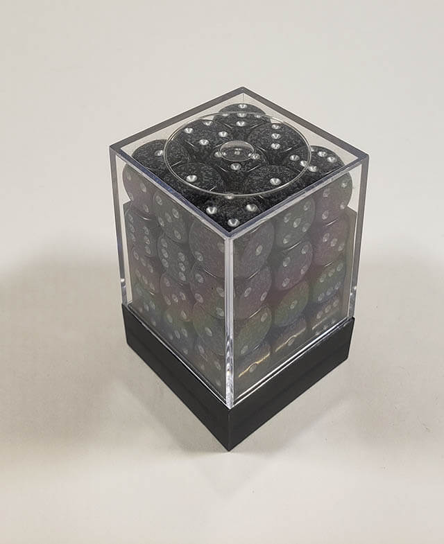 A close up of the Chessex specked ninja12mm d6 dice set in its package.