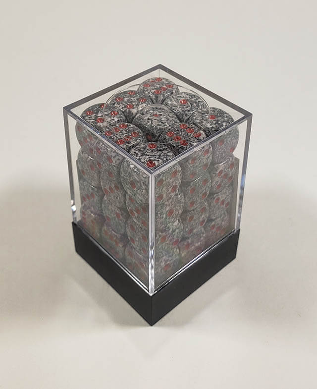 A close up of the Chessex specked granite 12mm d6 dice set in its package.