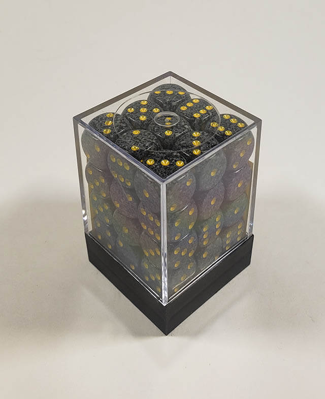 A close up of the Chessex specked urban camp 12mm d6 dice set in its package.