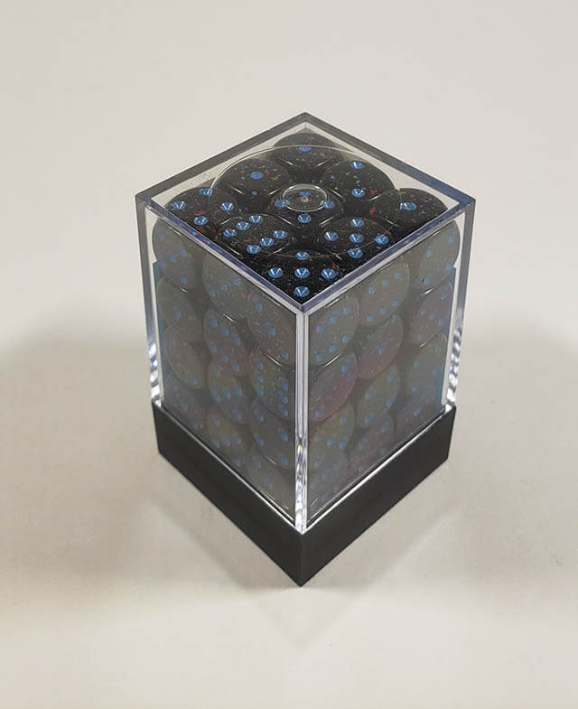 A close up of the Chessex specked blue stars 12mm d6 dice set in its package.