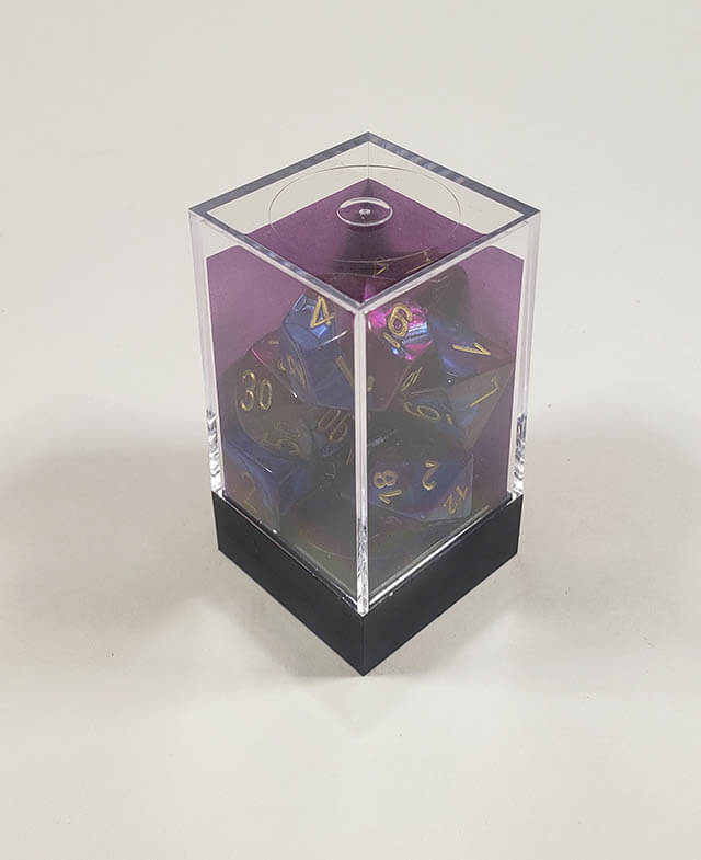 A close up of the Chessex Gemini Blue and Purple polyhedral dice set in its package.