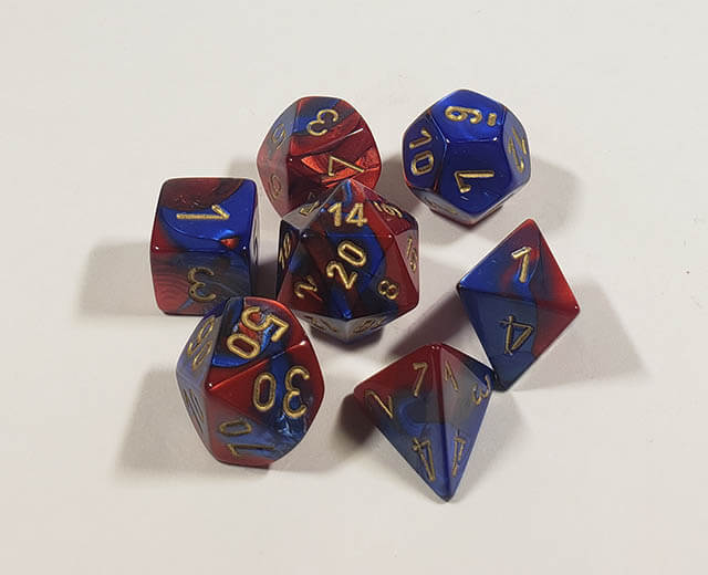 A close up of the Chessex Gemini Blue and Redy polyhedral dice set.