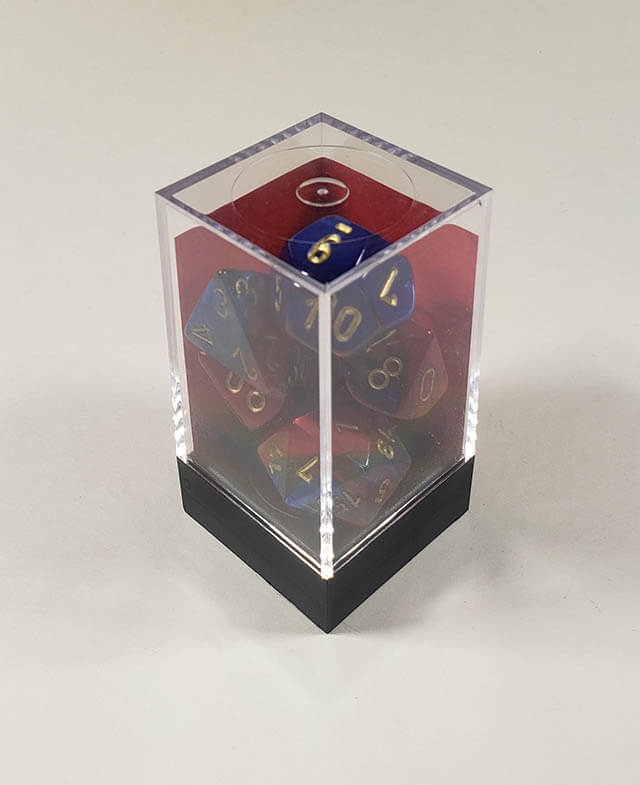 A close up of the Chessex Gemini Blue and Red polyhedral dice set in its package.