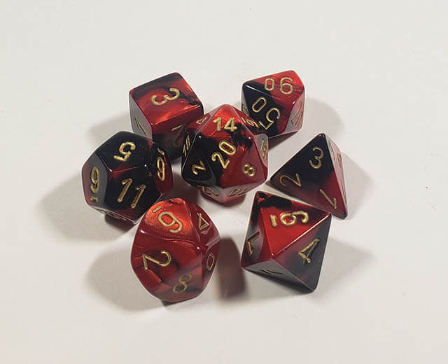A close up of the Chessex Gemini Black and Red polyhedral dice set.