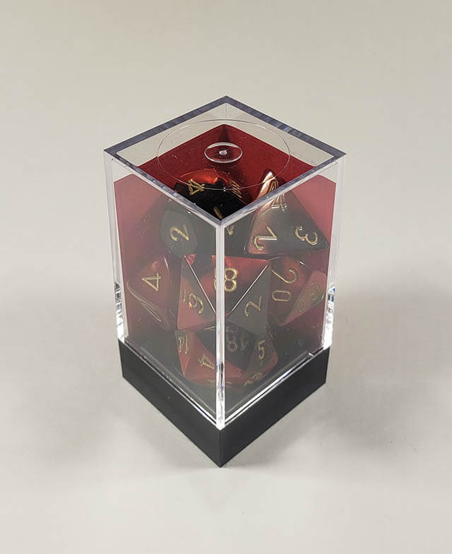 A close up of the Chessex Gemini Black and Red polyhedral dice set in its package.