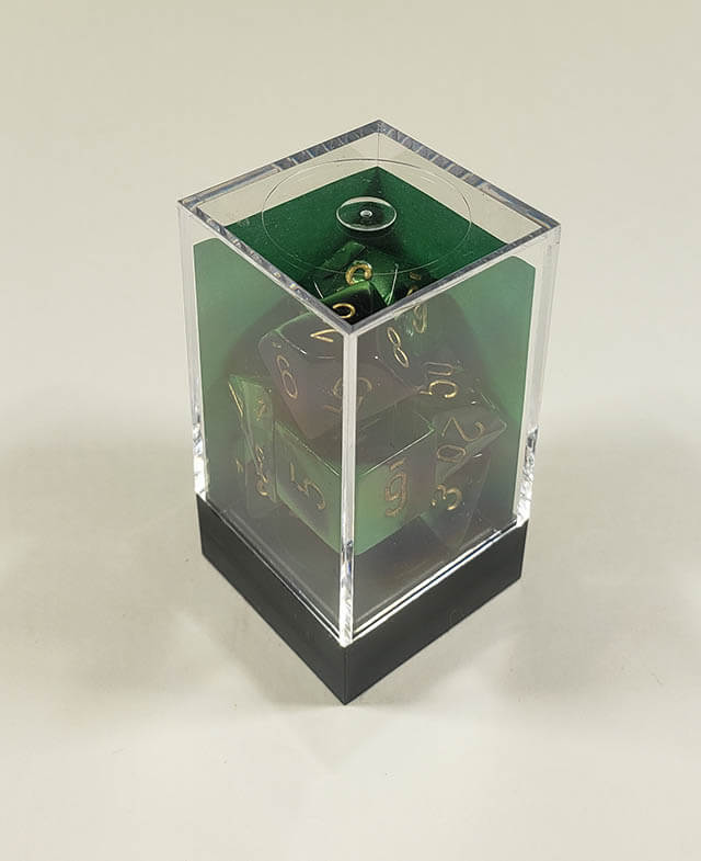 A close up of the Chessex Gemini Black and Green polyhedral dice set in its package.