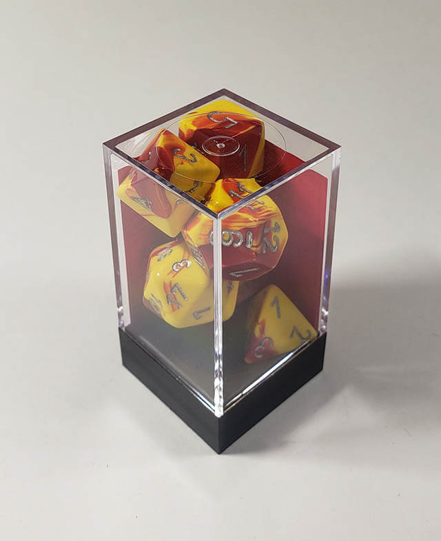 A close up of the Chessex Gemini Red and Yellow polyhedral dice set in its package.