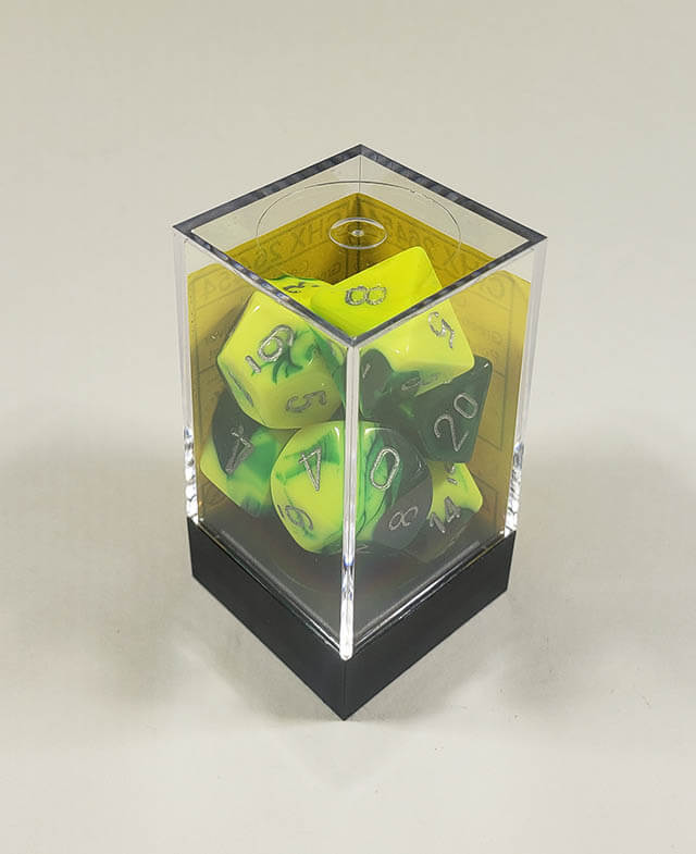 A close up of the Chessex Gemini Green and Yellow polyhedral dice set in its package.