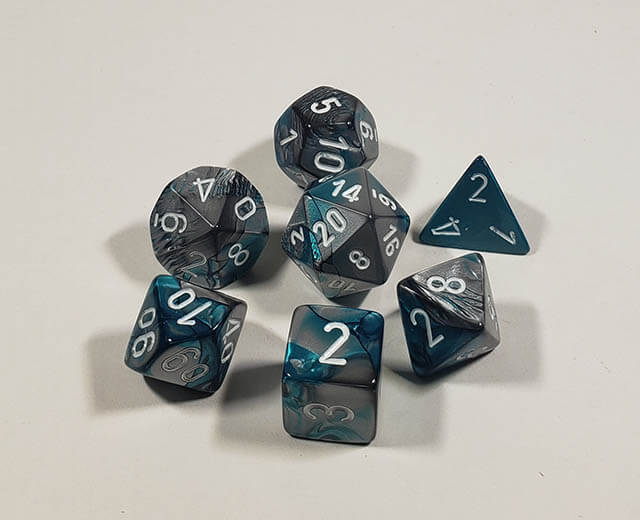 A close up of the Chessex Gemini Steel and Teal polyhedral dice set.
