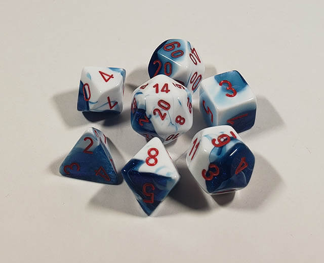 A close up of the Chessex Gemini Astral Blue and white polyhedral dice set.