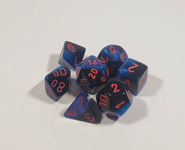 A close up of the Chessex Gemini Black and Starlight polyhedral dice set.