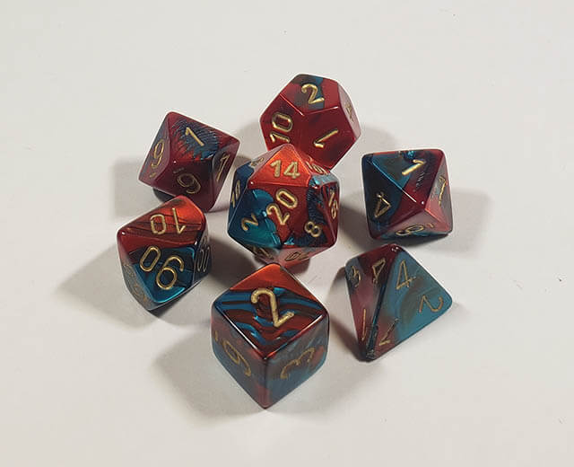 A close up of the Chessex Gemini Red and Teal polyhedral dice set.