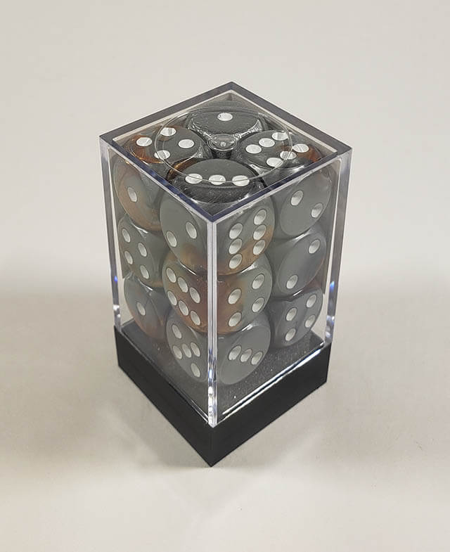 A close up of the Chessex Gemini Copper and Steel 16mm d6 dice set in its package.