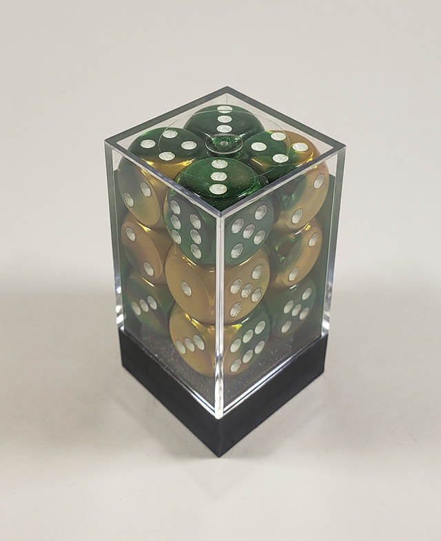 A close up of the Chessex Gemini Gold and Green 16mm d6 dice set in its package.