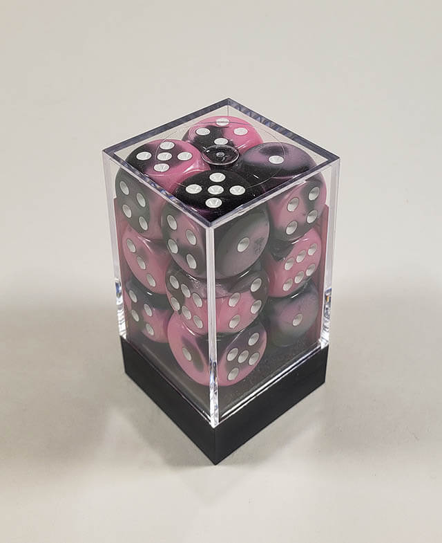 A close up of the Chessex Gemini Black and Pink 16mm d6 dice set in its package.