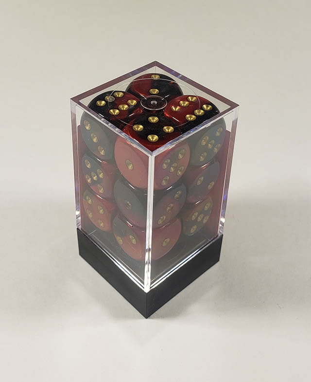 A close up of the Chessex Gemini Black and Red 16mm d6 dice set in its package.